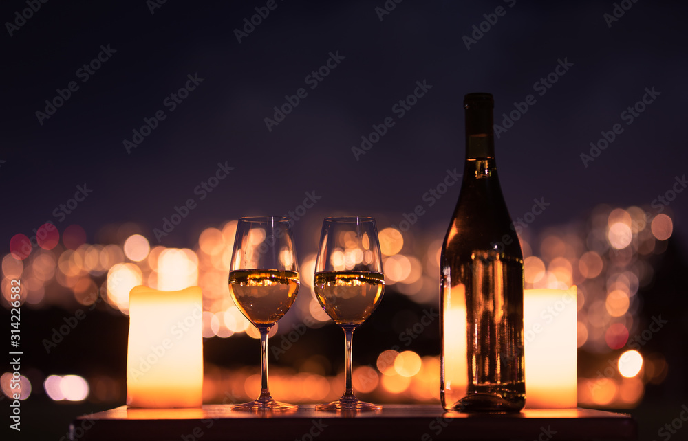 Fototapeta Candlelight dinner with wine and romantic city view.