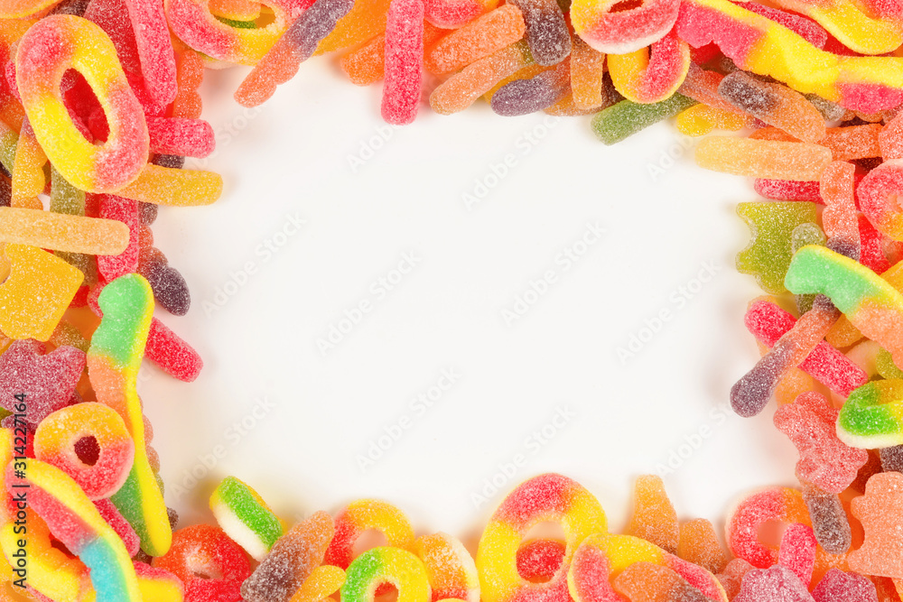 Frame of assorted gummy candies isolated on white. Top view. Space for text or design. Frame of assorted gummy candies isolated on white. Top view. Space for text or design.