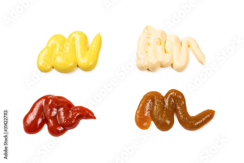 Ketchup and yellow sauce splashes isolated on white background