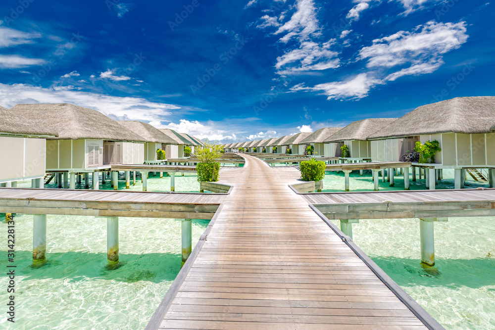 Panoramic landscape of Maldives beach. Tropical panorama, luxury water villa resort with wooden pier or jetty. Luxury travel destination background for summer holiday and vacation concept.