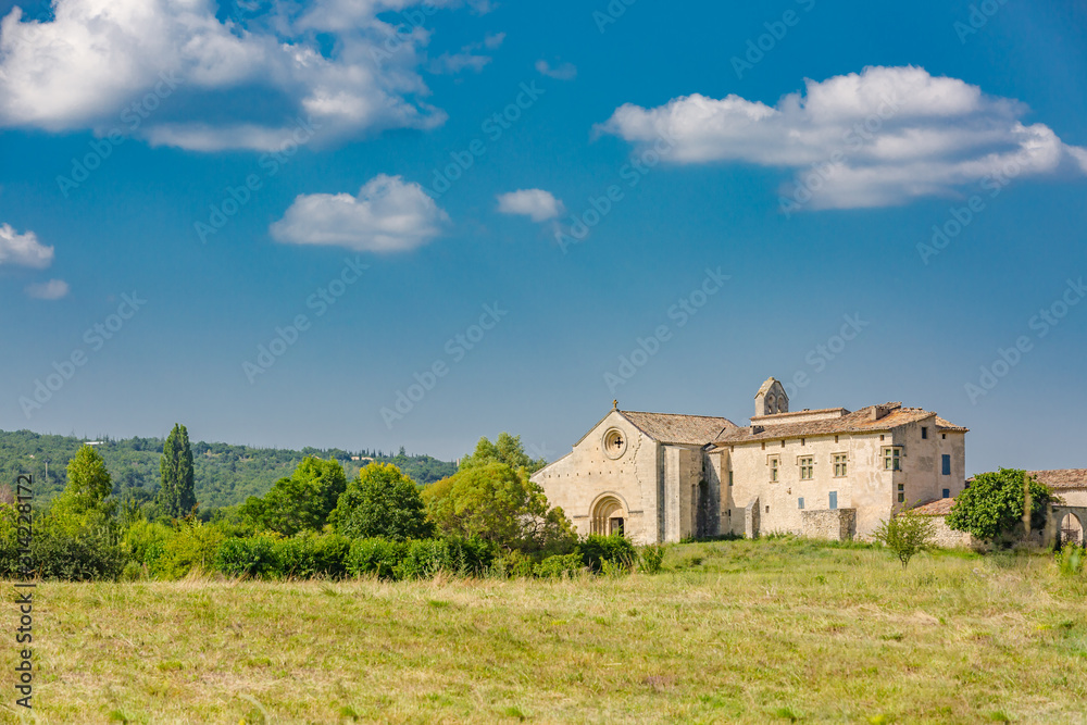 Salagon - tourist destination, Provence, France, famous for herbal, medicinal plants. Traditional stony church tower in the countryside of Provence Alpes Cote d Azur, France, a sunny day with blue sky