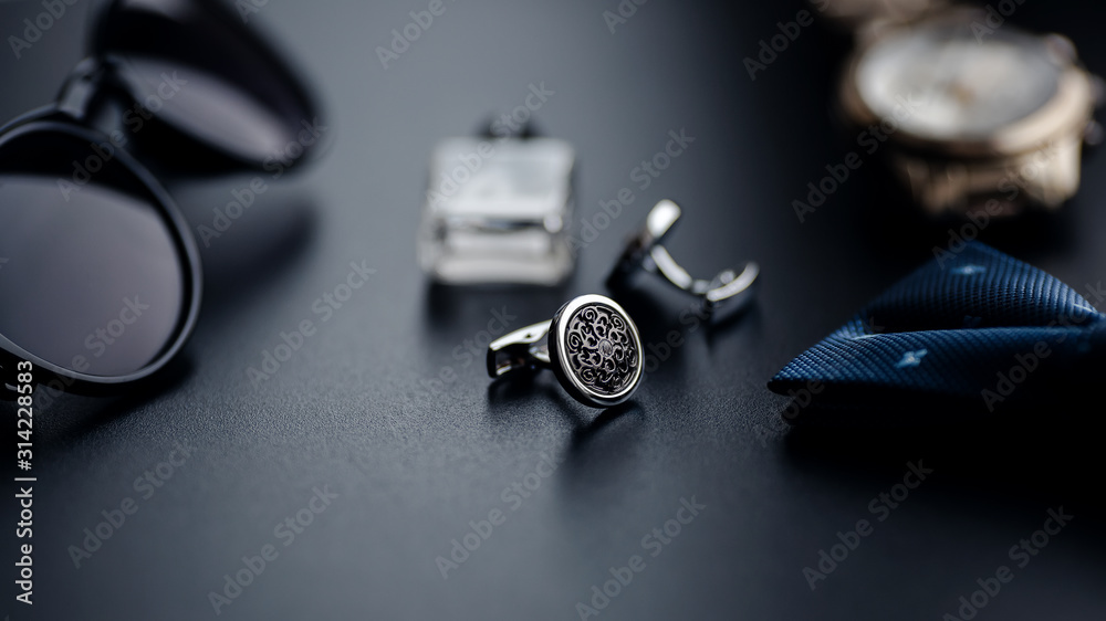 Luxury fashion men's cufflinks. Accessories for tuxedo, butterfly, tie, handkerchief, style watch and smartphone, car key isolated on the black background. Luxury fashion men's cufflinks. Accessories for tuxedo, butterfly, tie, handkerchief, style watch and smartphone, car key isolated on the black background.
