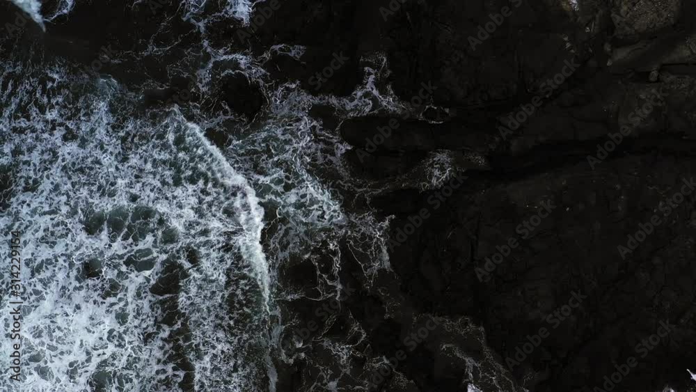 Top down view of giant ocean waves crashing and foaming Top down view of giant ocean waves crashing and foaming