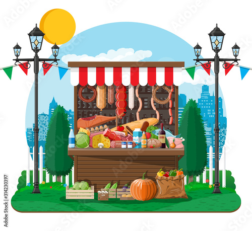 Traditional market wooden food stall full of food with flags, crates. City park, street lamp and trees. Sky with clouds and sun. Fair, grocery and shopping. Vector illustration flat style