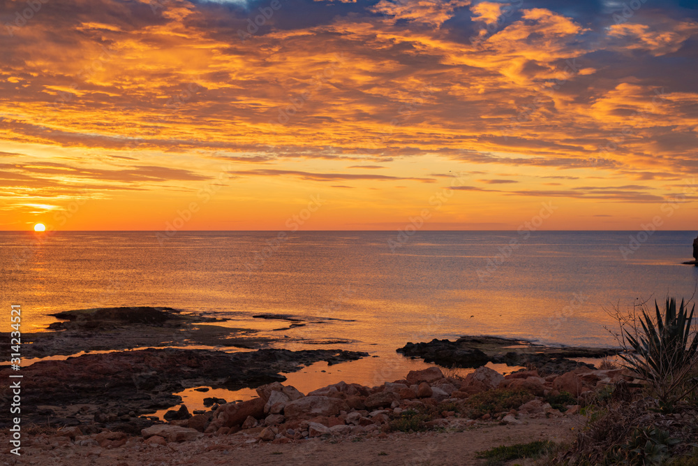Early sunrise and epic cloudy sky at rocky seashore coast of Torrevieja, Alicante, Spain. Mediterranean sea 2019 Early sunrise and epic cloudy sky at rocky seashore coast of Torrevieja, Alicante, Spain. Mediterranean sea 2019