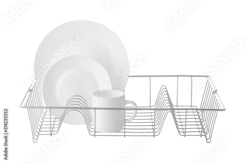 Set of white ceramic dishware on drainer photo