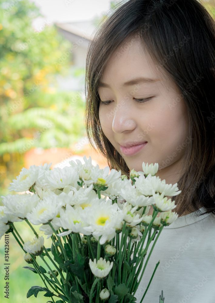 Woman holding white flowers Woman holding white flowers
