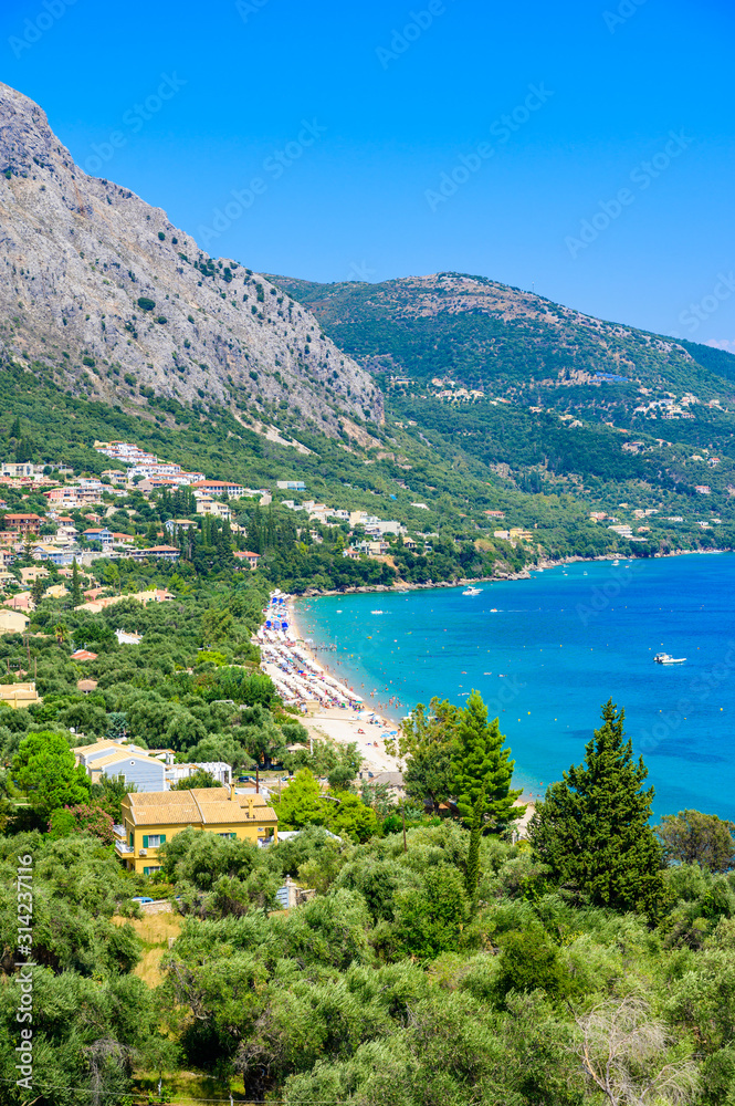 Barbati Beach with crystal clear azure water in beautiful landscape scenery - paradise coastline of Corfu island, Ionian archipelago, Greece.