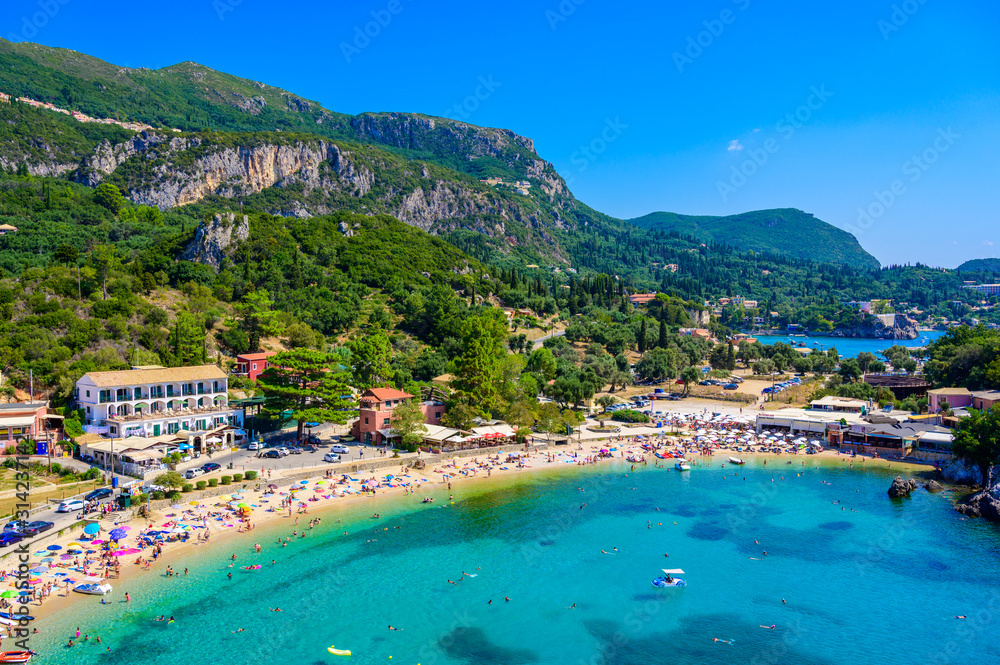 Agios Spiridon Beach with crystal clear azure water and white beach in beautiful landscape scenery - paradise coastline of Corfu island at Paleokastritsa, Ionian archipelago, Greece.