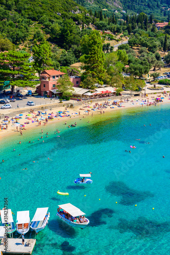 Agios Spiridon Beach with crystal clear azure water and white beach in beautiful landscape scenery - paradise coastline of Corfu island at Paleokastritsa, Ionian archipelago, Greece.