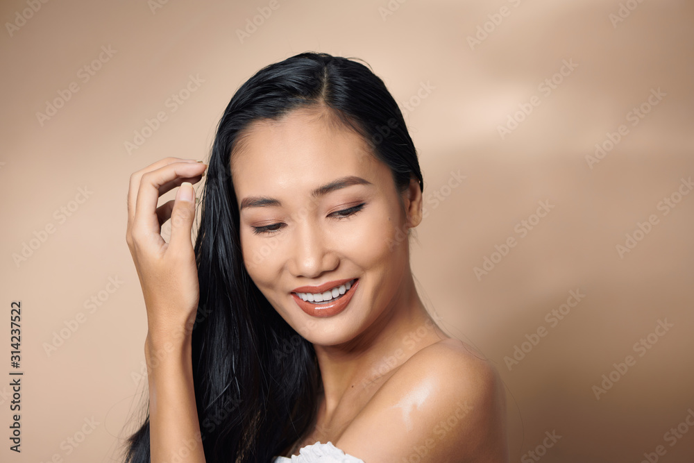 Beautiful woman tanned skin happy beauty smile over gray background Beautiful woman tanned skin happy beauty smile over gray background