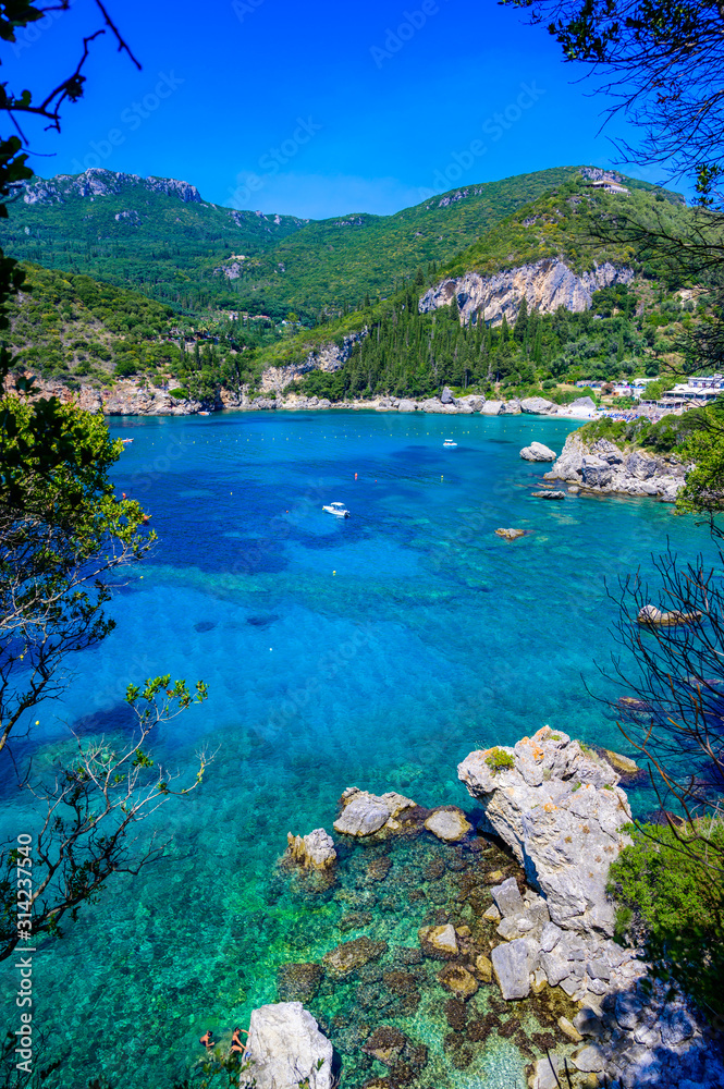 Fototapeta premium Paleokastritsa - Paradise coastline scenery with crystal clear azure water in Bay at white beach - Corfu, Ionian island, Greece, Europe