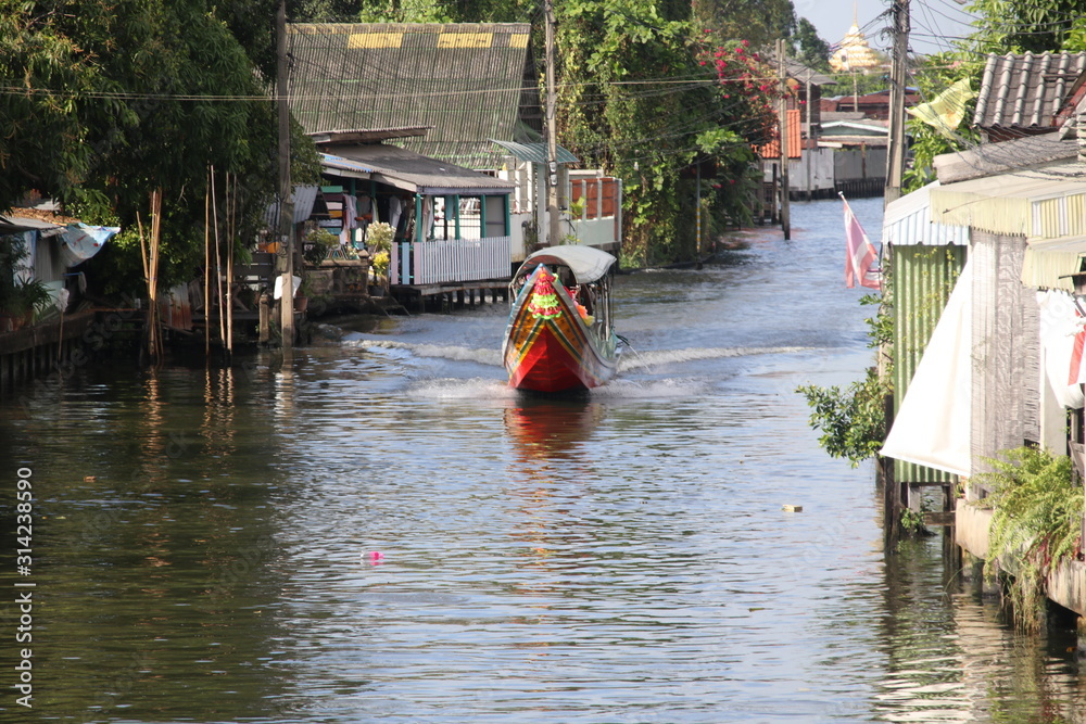 Long-tailed boat is sailing in canal, Bangkok, Thailand. Long-tailed boat is sailing in canal, Bangkok, Thailand.