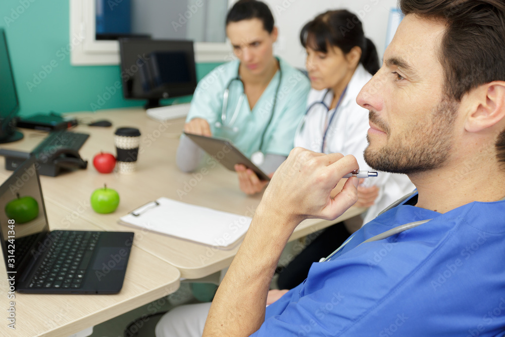 doctor thinking about medical problem in cooperation with physicians