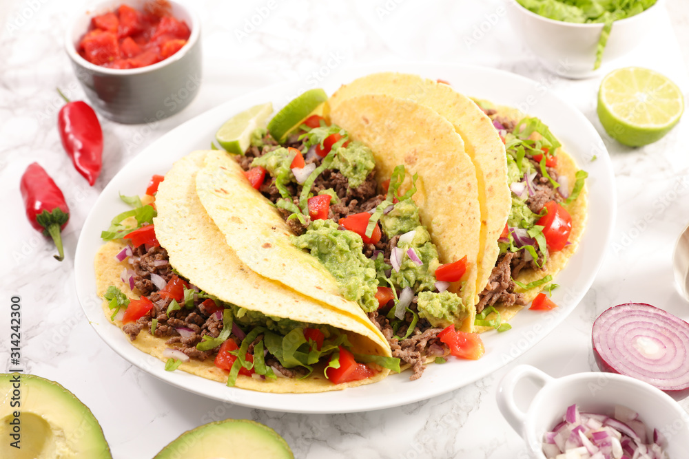 tacos with guacamole, beef, tomato and cheese- tortilla bread