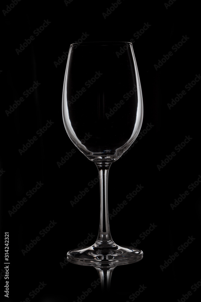 Glass wine glass stands on glass on black background