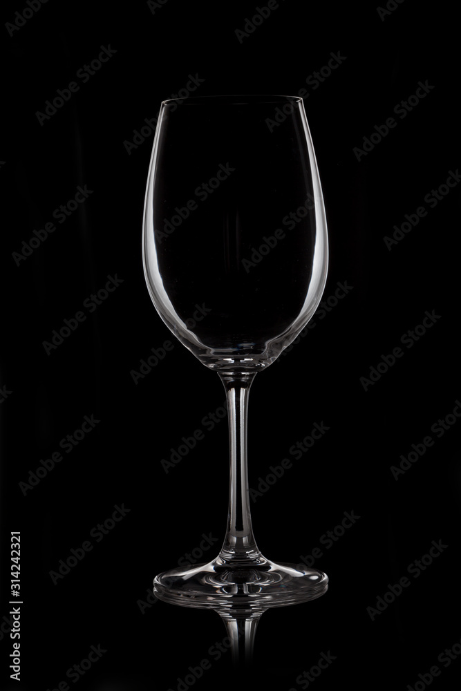 Glass wine glass stands on glass on black background Glass wine glass stands on glass on black background