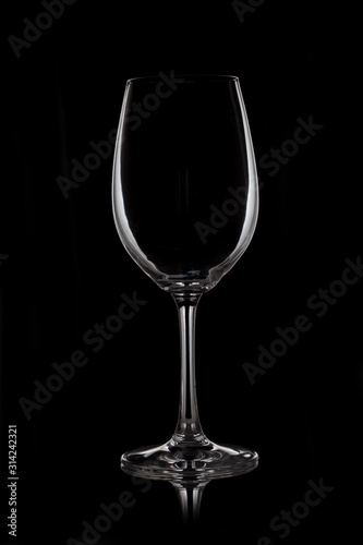 Glass wine glass stands on glass on black background