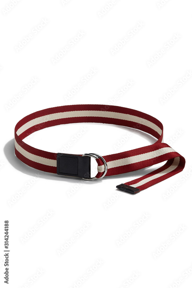 Subject shot of a red canvas belt with a white stripe, black leather trim and decorated with a steel D-rings buckle. The stylish belt is isolated on the white background. Subject shot of a red canvas belt with a white stripe, black leather trim and decorated with a steel D-rings buckle. The stylish belt is isolated on the white background.