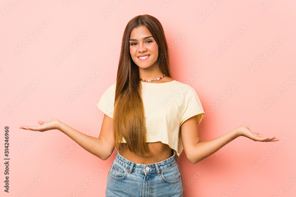 Young slim woman showing a welcome expression. Young slim woman showing a welcome expression.