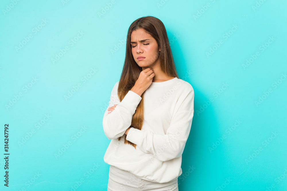 Young slim woman suffers pain in throat due a virus or infection. Young slim woman suffers pain in throat due a virus or infection.