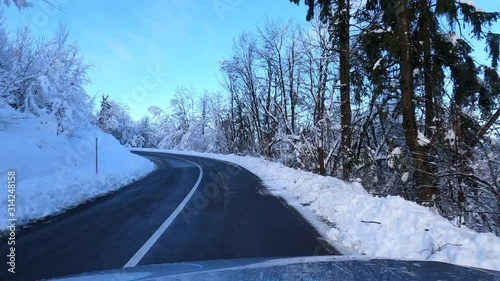 Driving car on a asphalt winter road on a sunny day