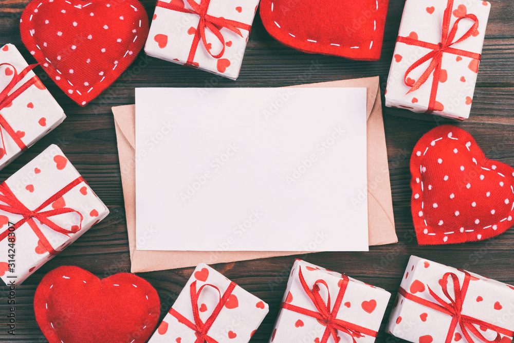 Obraz premium Envelope Mail with Red Heart and gift box over Dark Wooden Background. Valentine Day Card, Love or Wedding Greeting Concept