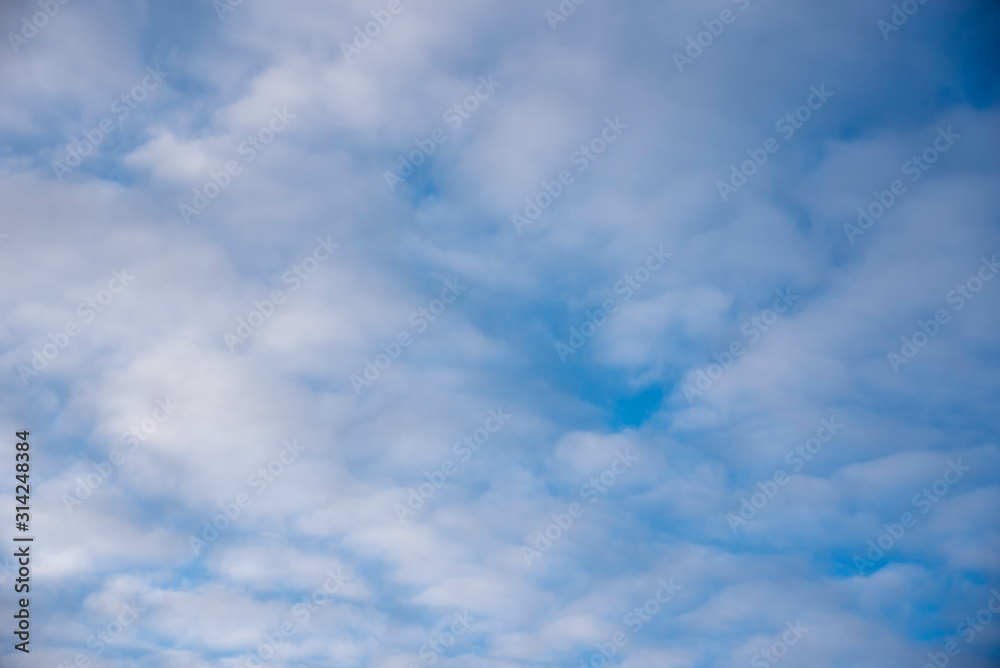 Bright blue winter sky with white clouds.