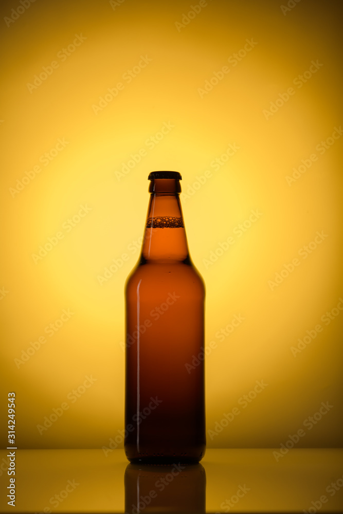 bottle of beer or a lemonade on a yellow background bottle of beer or a lemonade on a yellow background