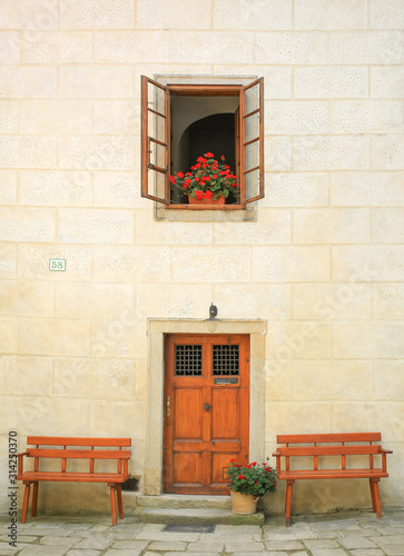 building interior with red flowers on the window