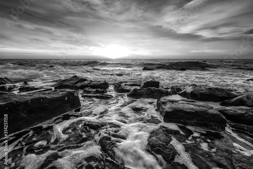 Stunning black and white seascape with the amazing sky over the water. Water motion blur