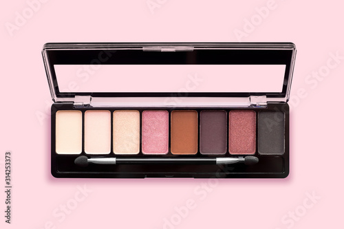 Canvas Print Palette of eyeshadows in brown tones, matte and shimmer eyeshadows on a pink background, top view