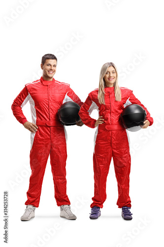 Team of a male and female car racers holding helmet