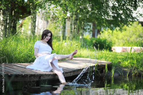 Pregnant woman in nature for a walk summer © alexkich