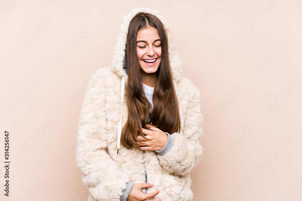 Young caucasian woman posing isolated laughs happily and has fun keeping hands on stomach. Young caucasian woman posing isolated laughs happily and has fun keeping hands on stomach.