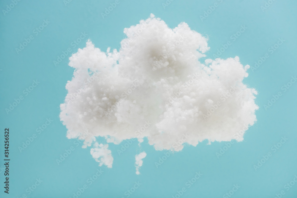 white fluffy cloud made of cotton wool isolated on blue background