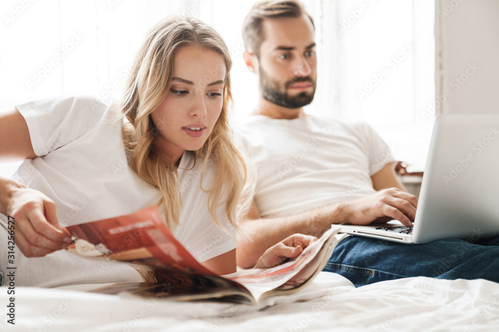 Beautiful young couple relaxing on bed Beautiful young couple relaxing on bed