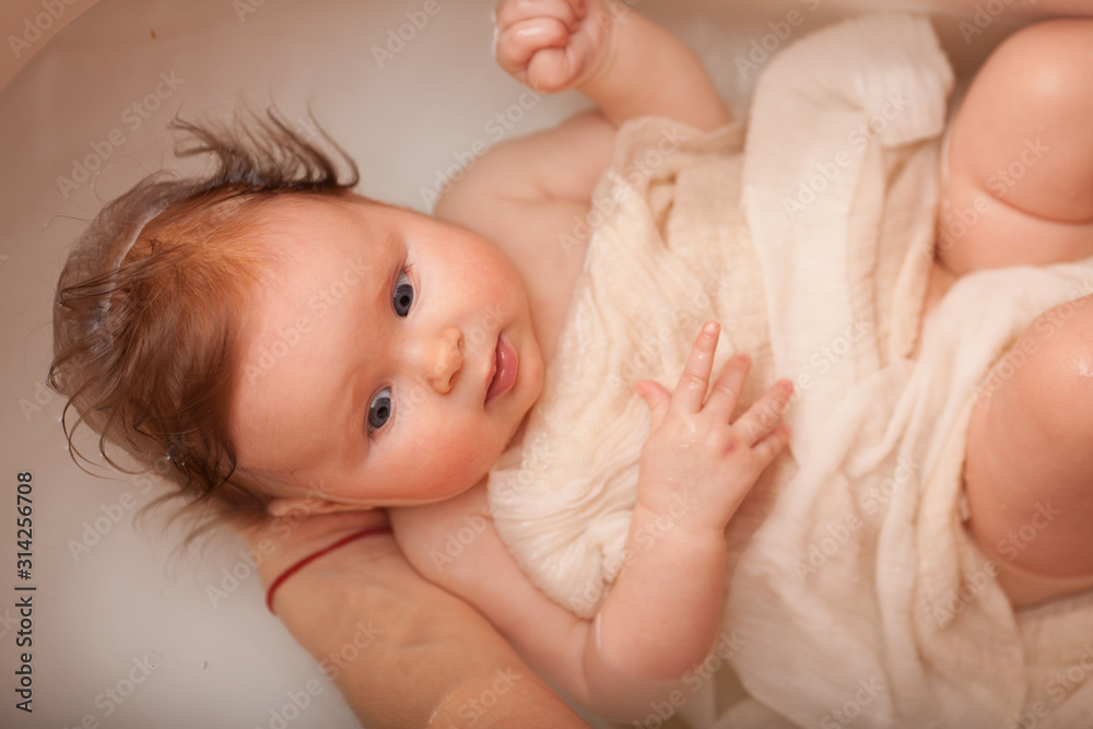 cute newborn baby bathes in the bathroom. The concept of a toddlers ' swimming cute newborn baby bathes in the bathroom. The concept of a toddlers ' swimming
