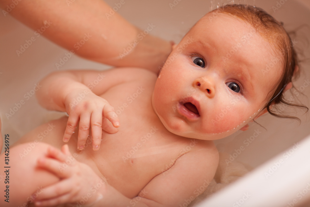 cute newborn baby bathes in the bathroom. The concept of a toddlers ' swimming cute newborn baby bathes in the bathroom. The concept of a toddlers ' swimming