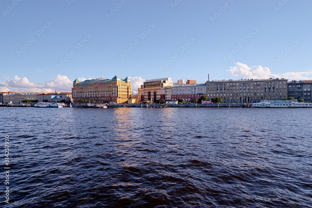 Embankment at Neva river with docked various boats and ships, a view from afar. Petersburg.