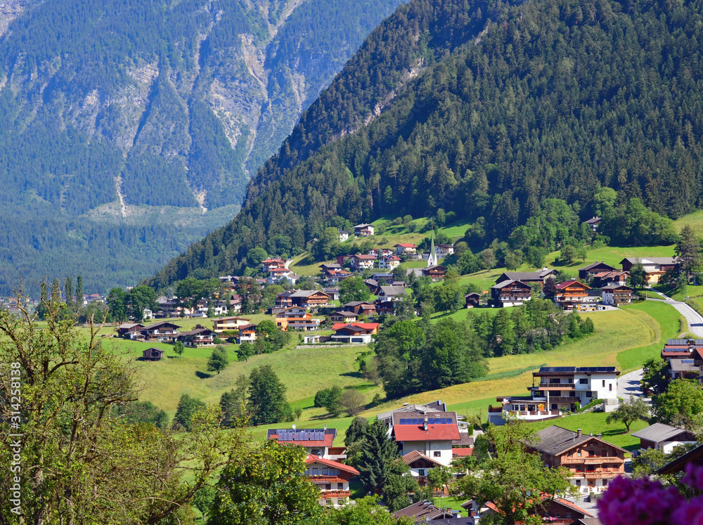 Obraz premium Austria europe mountain landscape with village and natural scene grass lands.