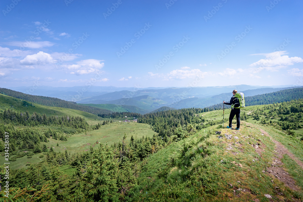Active lifestyle. Traveling, hiking and trekking concept. Young woman with backpack in the Carpathian mountains.