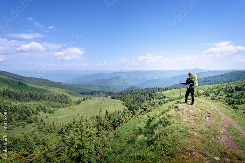 Active lifestyle. Traveling, hiking and trekking concept. Young woman with backpack in the Carpathian mountains.