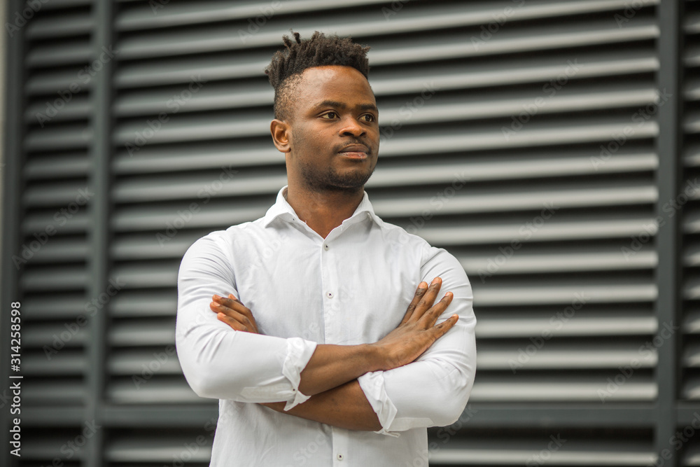 handsome young african man in a white shirt handsome young african man in a white shirt