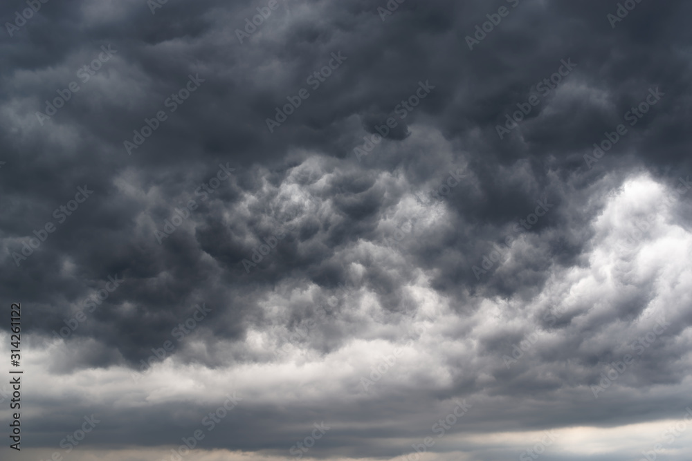 Low angle view of dramatic sky and dark stormy clouds
