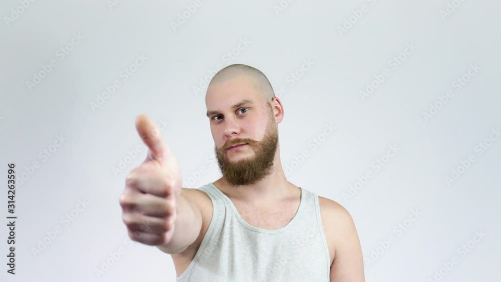 Male shows like and dislike.Bald man with beard showing thumbs up and down. Male shows like and dislike.Bald man with beard showing thumbs up and down.