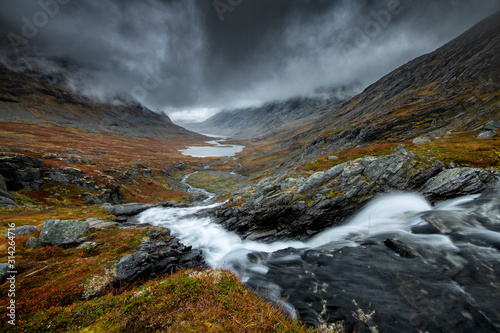 Fototapeta Naklejka Na Ścianę i Meble -  Dark landscape of Norway mountains covered with heavy clouds