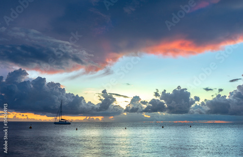 Panorama of beautiful sunset over ocean and sailboats