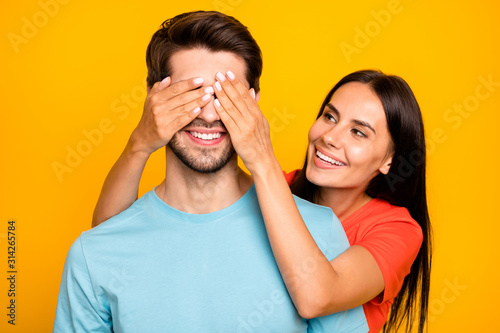 Guess who. Photo of two adorable guy lady people couple closing eyes romance surprise visit wear casual blue orange t-shirts isolated yellow color background © deagreez