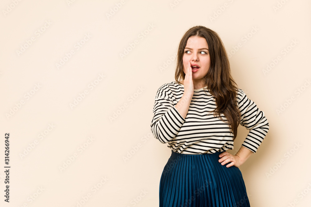 Young curvy woman is saying a secret hot braking news and looking aside Young curvy woman is saying a secret hot braking news and looking aside